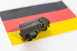War, military threat, military power concept. Germany. Tanks toy near German flag on black background top view