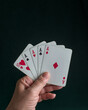a hand holding a poker aces Four of a kind