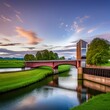 a bascule bridge stretching across a serene river creating a timeless image of pastoral beauty.
