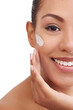 © peopleimages.com - Happy woman, portrait and skincare with face cream for beauty or moisturizing on a white studio background. Female person, brunette or model with smile for anti aging, lotion or SPF in dermatology