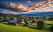 © Sergiy - Panoramic top view of an old small abandoned ruined village on the hills with thatched roof huts at sunset with clouds in the sky