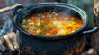 Boiling cauldron simmers hearty vegetable soup 