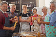 © peopleimages.com - Cooking, pasta class and portrait of people in kitchen learning recipe for cuisine, culinary and chef skills. Retirement, teacher and and men and women with ingredients, dough and food for dinner