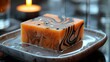 Elegant bar of soap with fiery swirl designs and misty vapors on a soap dish