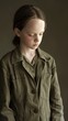 © ProPhotos - A young girl wearing an army green jacket with her eyes closed.