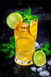Dark and stormy alcoholic cocktail long drink with dark rum, ginger ale, lime, mint and ice, black bar counter background
