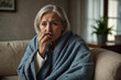 Elderly female person with seasonal flu or cold sneezing in napkin, feeling unhealthy with influenza.