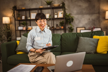 Wall Mural - Mature japanese woman have consultation via video call work from home