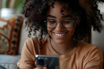 A young woman happily using a smartphone while working or studying remotely. Concept Young woman, smartphone, remote work/study, happy expression
