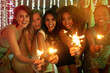Portrait, party and people with sparklers, celebration and excited with happiness, cheerful and achievement. Fireworks, group or event with joy, birthday or social gathering with diversity or holiday