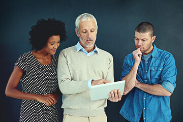 Poster - Mature, businessman and tablet with team in studio as mentor for coaching or training for feedback on work productivity. Boss, staff and digital technology for ideas or review of project proposal