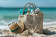 beach essentials with straw bag and seashells on sandy shore