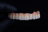 Fototapeta Zwierzęta - Two stages of making full dental zirkonium prosthesis on titanium bar. Raw before sintering and layered or painted zirkonium.