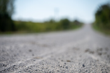 tire tracks left in the dust and rock of a gravel road