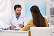 Doctor consulting patient during appointment in clinic