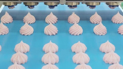 Poster - A conveyor belt with pink frosting on it. The frosting is in the shape of a flower