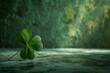 Four-leaf clover on a textured surface with a green blurred background