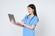 Smiling young asian woman doctor with stethoscope using laptop isolate on white background.
