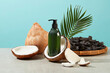 Blue background against unlabeled green bottle contains product made by black locust and coconut featured in center. Photo for advertising with front view