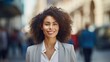 © mariiaplo - Confident Young Businesswoman Smiling in Urban Setting