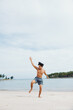 Muscular Asian Man Running on Beach, Embracing Fitness Lifestyle: A Portrait of an Attractive Male Athlete in Training