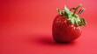 Juicy red strawberries on a red background. Summer harvest, sweet snack.