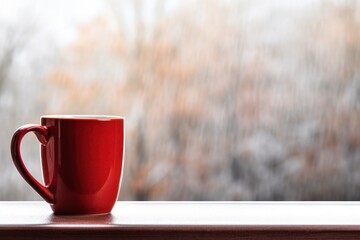 Poster - a red cup on a window sill