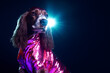 Creative animal concept. English Cocker Spaniel dog puppy in disco neon glitter glam shiny glow sequin outfit, copy text space. commercial, editorial advertisement party invitation invite, surreal	

