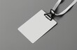 Mockup of a blank white nametag label lying on a grey background, perfect for presentations, events, and identification purposes