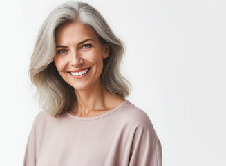 Retirement Age Woman with a magnificent smile, wearing plain clothes in pastel colors, isolated on a white background