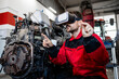 Mechanic using virtual reality glasses and AI technologies while repairing vehicle engine in workshop.