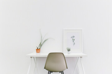 Wall Mural - A minimalist white desk chair blending seamlessly into its solid white surroundings.