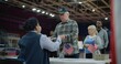Elderly man talks with polling officer and takes vote bulletin. Multi cultural American citizens come to vote in polling station. Political races of US presidential candidates. National Election Day.