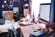 Selective focus shot of part of modern teen girls bedroom interior with computer on wooden desk, copy space