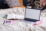 Fototapeta  - High angle view of laptop, textbooks and notebooks on bed in teenagers room interior, copy space
