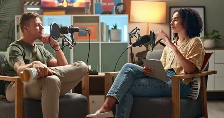 Poster - Happy people, interview and podcast with tablet or influencer in meeting, discussion or talk show at studio. Man and woman speaking on air together with mic for communication, live chat or recording