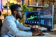 African financial analyst using computer for predictive analytics