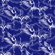 white silhouettes of cranes on the background of unusual clouds drawing in the dot technique. Seamless pattern, repeating background in two colors - blue and white