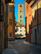 Medieval tower among old historic buildings in Alba, Italy.