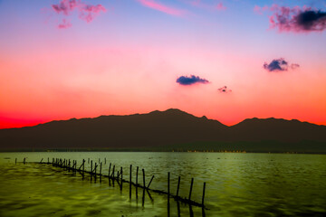 Sticker - Kwan Phayao Lake with the silhouette of the mountain range at sunset in Phayao Province