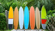 Colorful Surfboards Popping Against Lush Greenery.