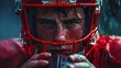 Artistic low-key image of an American Football player holding a helmet beside his face, capturing the essence of the game's toughness