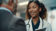 © Maksym - A close-up shot of a female doctor in a modern hospital setting, her reassuring smile complementing the information she shares on a tablet with a man in a business suit, fostering