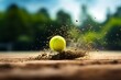 Tennis ball flying through the air with splashes of sand.
