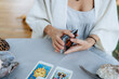 A woman is making tarot layout on the table