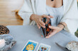 A woman is making tarot layout on the table