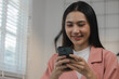 © PHOTO4U - A very pretty female employee was happily spending her lunch break in her private office after working all morning, beautiful Asian female employee sits in her private office while on her lunch break