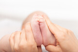 Fototapeta  - Physiotherapist performing development exercise with infant
