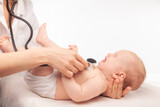 Fototapeta  - Pediatric Check-up Doctor Examining a Crying Baby with Stethoscope