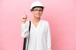 © luismolinero - Young architect Russian woman with helmet and holding blueprints isolated on pink background pointing up a great idea